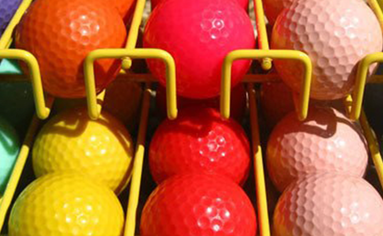 row of multi colored golf balls