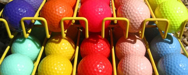 Row of mini golf balls in multiple colors